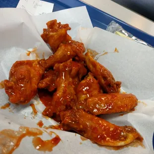 XXX-Hot wings, nice and crispy on the outside, and swimming in sauce at the bottom.