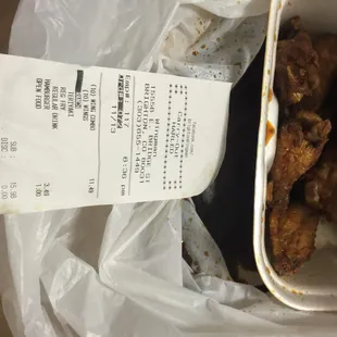 a receipt and a bowl of fried chicken
