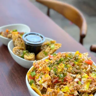 two bowls of nachos on a table