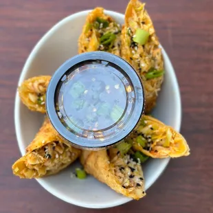 a plate of fried food with dipping sauce