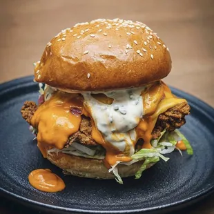 a chicken sandwich with cheese and lettuce