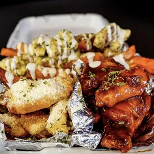 a plate of wings, fries, and carrots