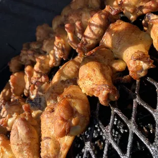 a close up of chicken wings being cooked on a grill