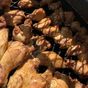 chicken wings cooking on a grill