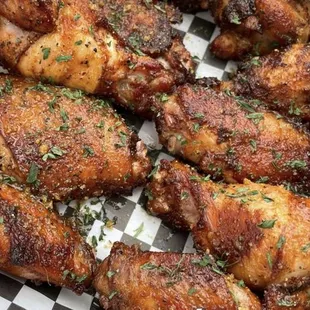 chicken wings in a basket with a checkered paper