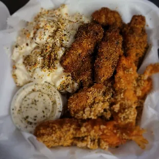 a basket of fried chicken and mashed potatoes
