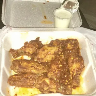 a tray of food with a spoon in it