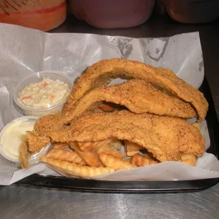 a basket of fried fish and fries