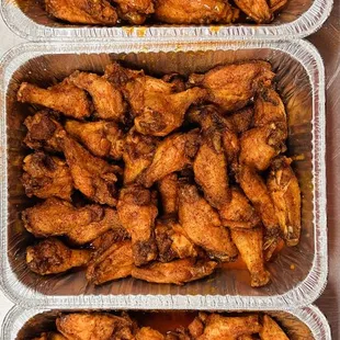 three trays of chicken wings