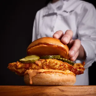a chef holding a sandwich