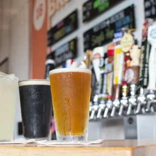 a row of beer glasses on a bar