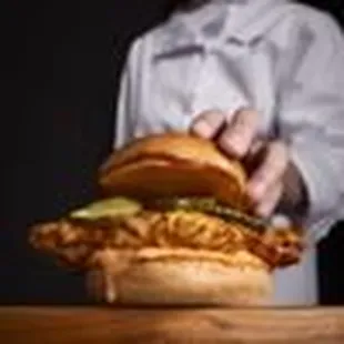 a chef holding a sandwich