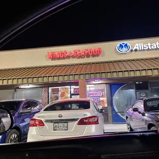 cars parked in front of a restaurant