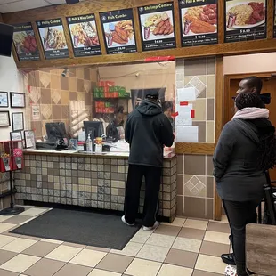 two people standing at the counter