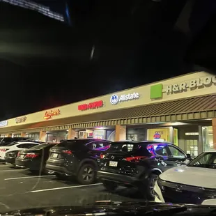 cars parked in a parking lot at night