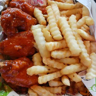 Medium heat chicken wings with French fries