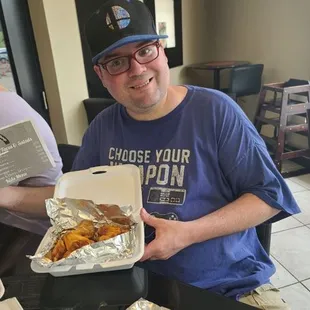 a man holding a box of food