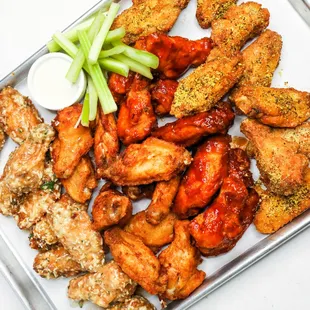 a platter of chicken wings and celery