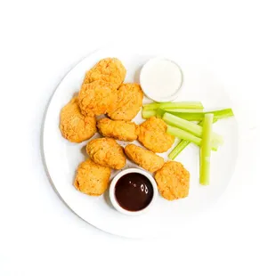 a plate of chicken nuggies and celery sticks