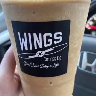 a hand holding a cup of coffee