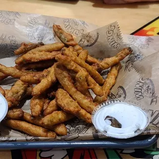 a basket of fries with dipping sauce