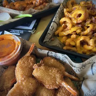 a tray of fries and a tray of macaroni and cheese