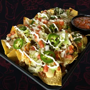 a plate of nachos with sauce