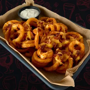 a tray of onion rings and dip