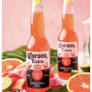 two bottles of coronano on a pink background