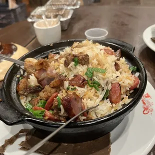 a bowl of rice with meat and vegetables