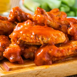 a plate of buffalo wings and celery