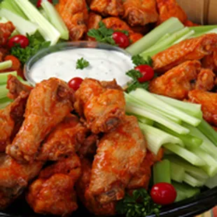 a platter of buffalo wings and celery