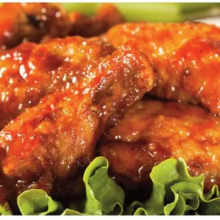a plate of chicken wings and lettuce