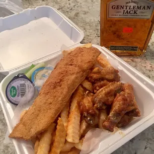 a fish and chips meal in a styrofoam container