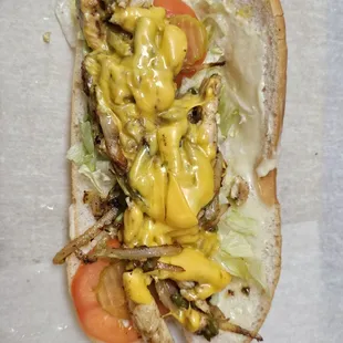 a chicken sandwich with cheese and lettuce