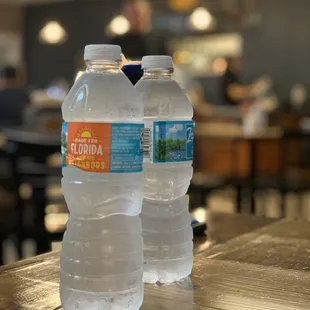 two bottled water bottles on a table