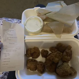 a tray of fried food and a receipt