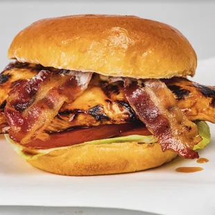 a chicken sandwich with bacon and lettuce