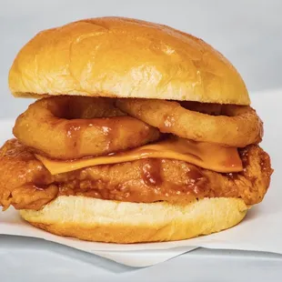 a chicken sandwich with onion rings