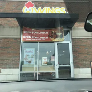 The store front from the outside, with two reserved pick up spaces