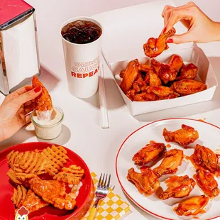 a plate of chicken wings and a plate of waffles