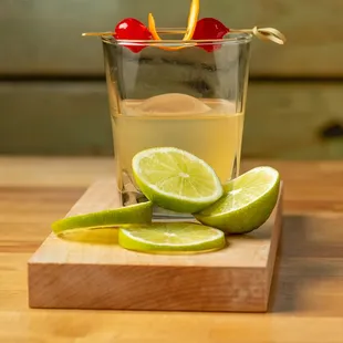 limes and cherries on a cutting board