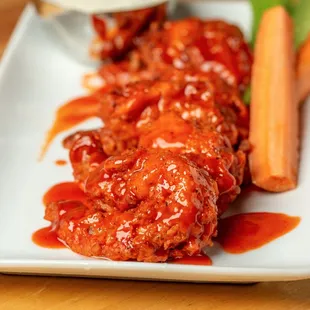 a plate of food with carrots and celery