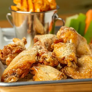 a plate of chicken wings and carrots