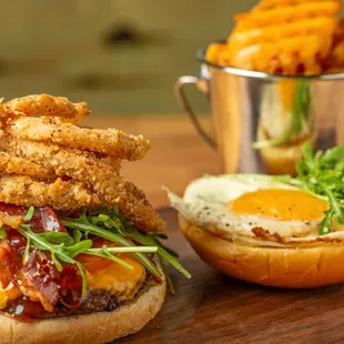 a burger with fried egg and bacon