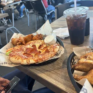 a pizza and a drink on a table