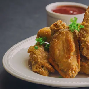 a plate of fried chicken wings