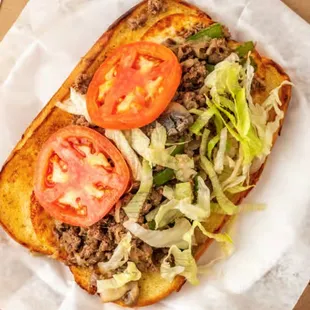 a sandwich with tomatoes and lettuce