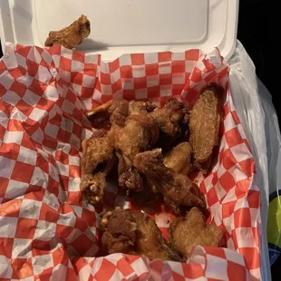 chicken wings in a red and white checkered basket