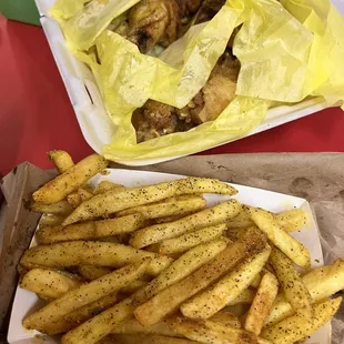 a tray of fries and a tray of meat